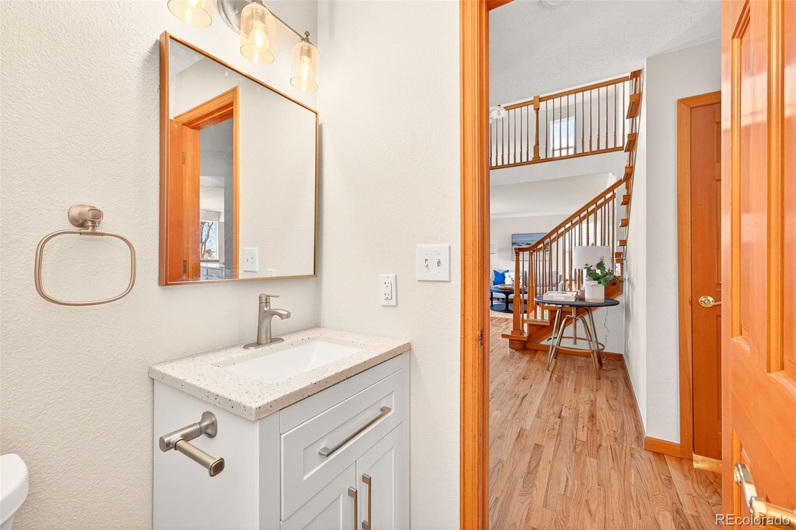 8852 Chestnut Hill Lane Highlands Ranch, CO 80130 - Photo 13 of 38 a bathroom with a sink a mirror and a window
