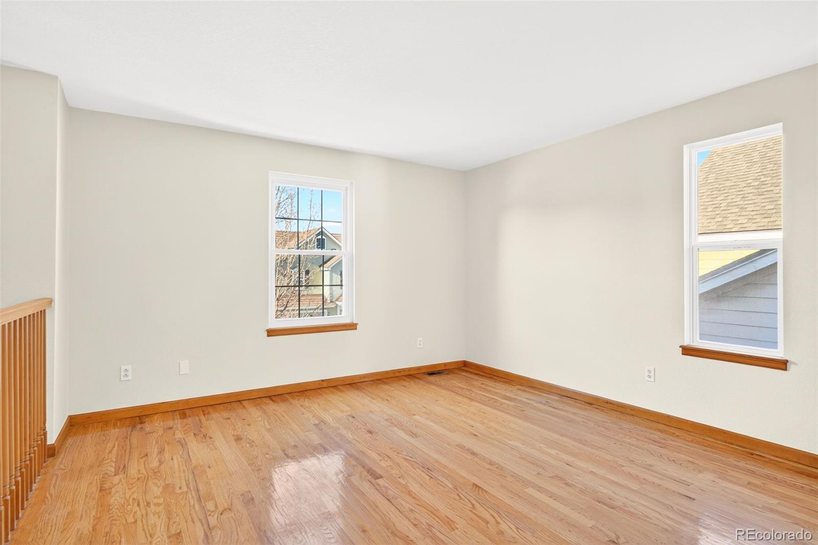 8852 Chestnut Hill Lane Highlands Ranch, CO 80130 - Photo 17 of 38 a view of an empty room with wooden floor and a window