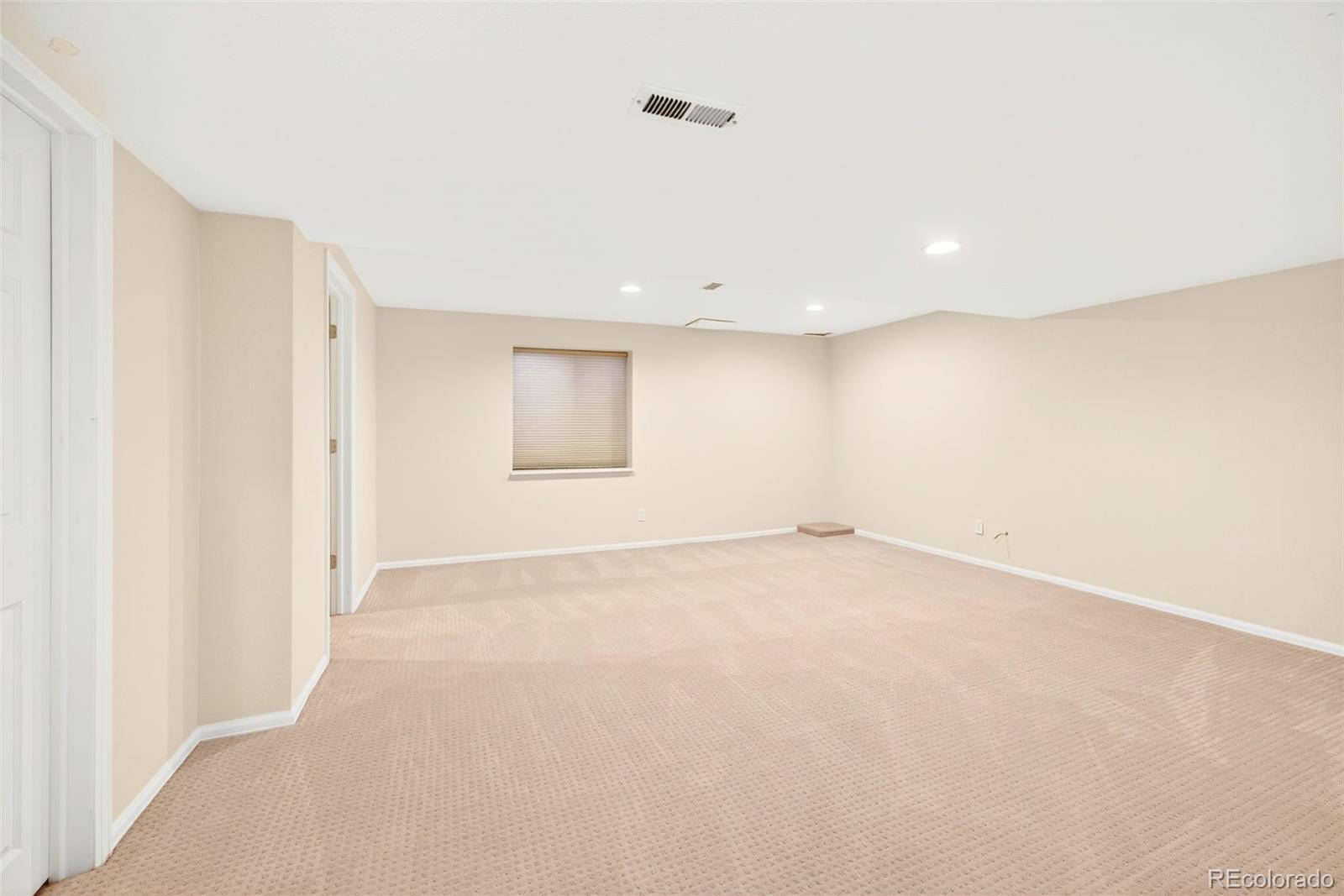 8852 Chestnut Hill Lane Highlands Ranch, CO 80130 - Photo 27 of 38 an empty room with a empty space and windows