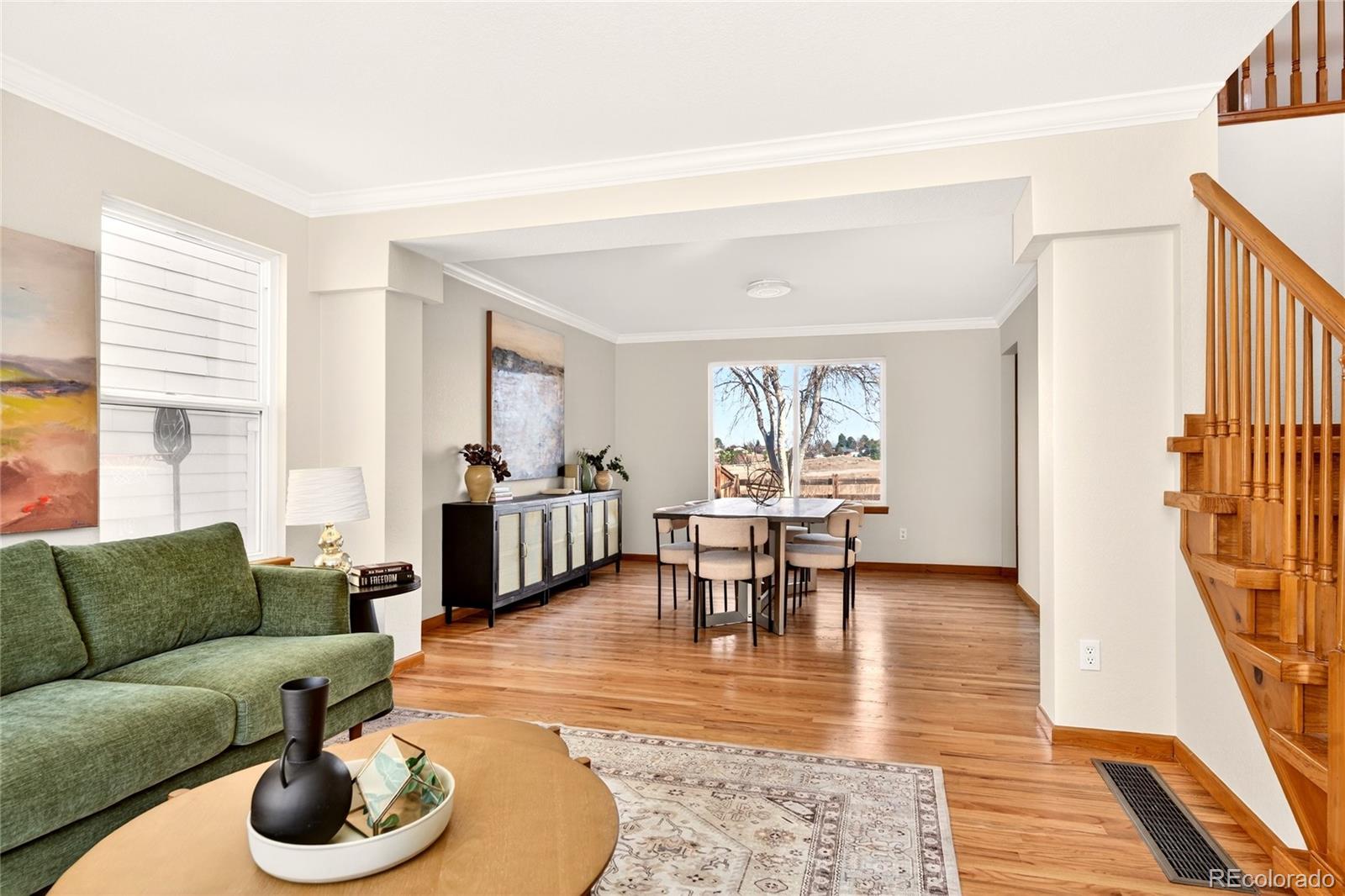 8852 Chestnut Hill Lane Highlands Ranch, CO 80130 - Photo 4 of 38 a living room with furniture and a wooden floor