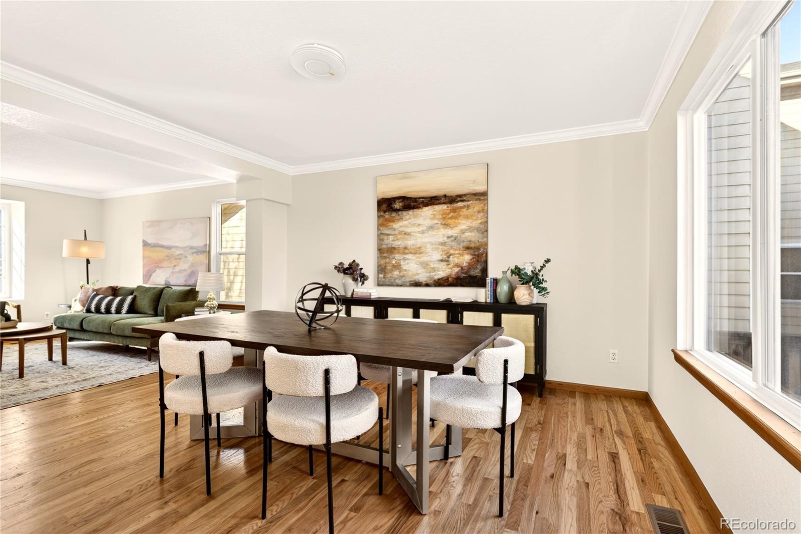 8852 Chestnut Hill Lane Highlands Ranch, CO 80130 - Photo 5 of 38 a view of a dining room with furniture and wooden floor