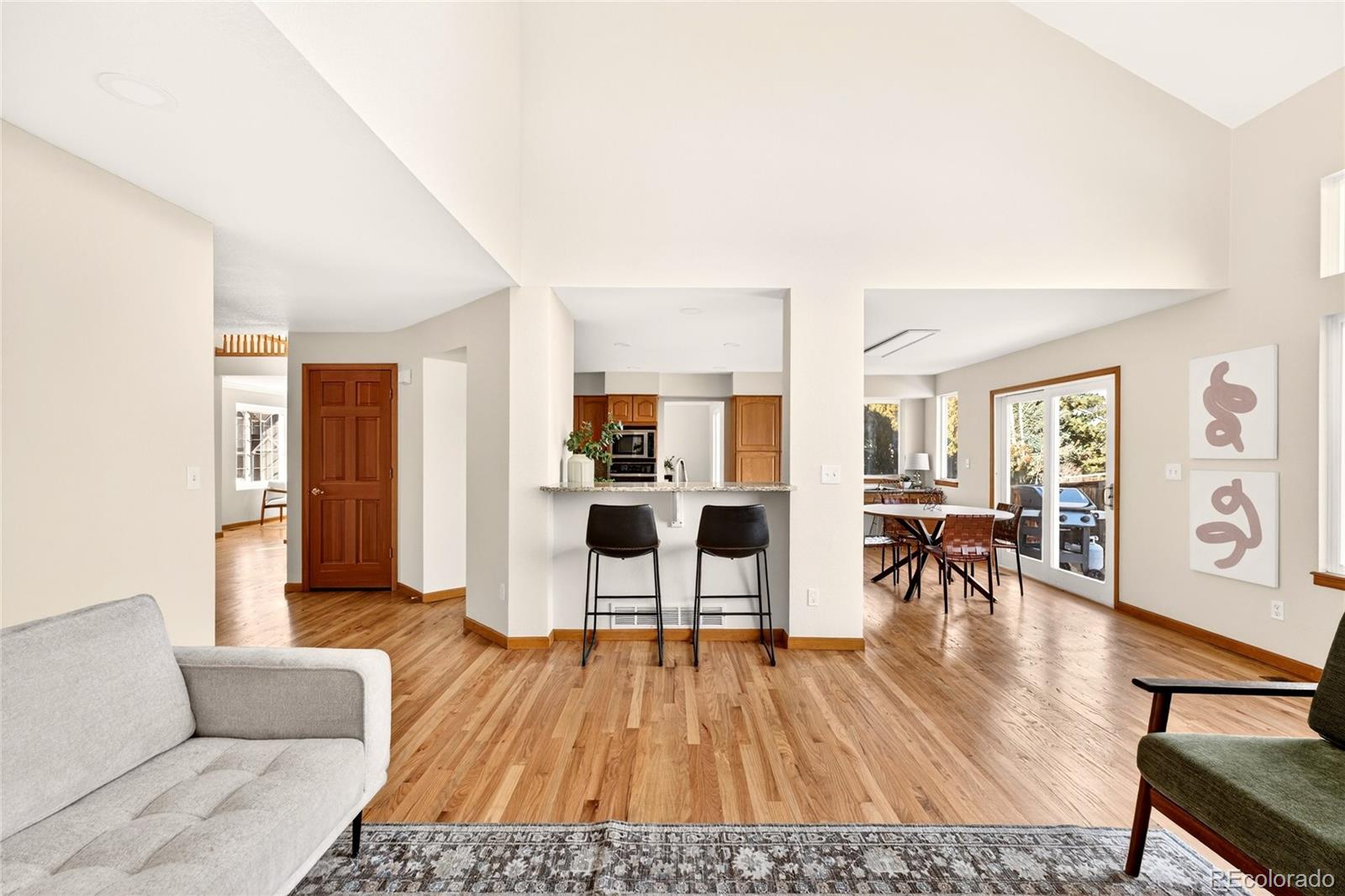 8852 Chestnut Hill Lane Highlands Ranch, CO 80130 - Photo 10 of 38 a living room with furniture and a wooden floor