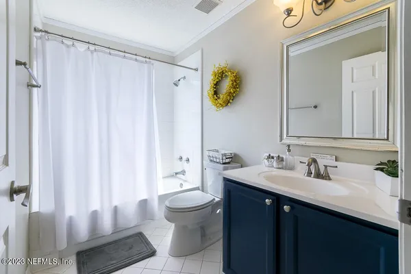a bathroom with a sink vanity and a mirror