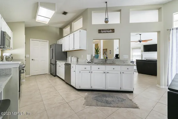 a kitchen with cabinets and window