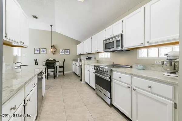 a kitchen with stainless steel appliances granite countertop a sink and cabinets