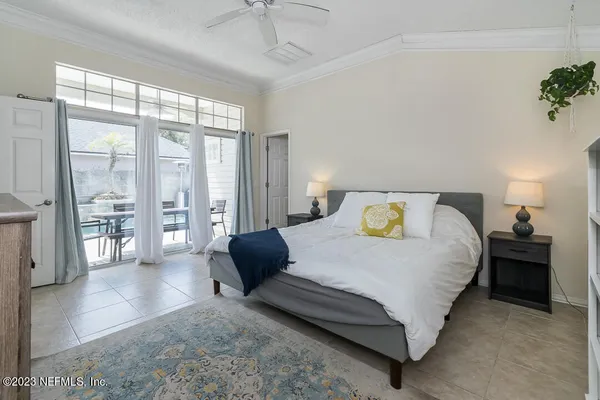 a bedroom with a balcony a bed and a chandelier