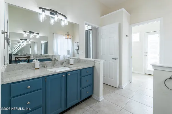 a bathroom with a double vanity sink and a mirror