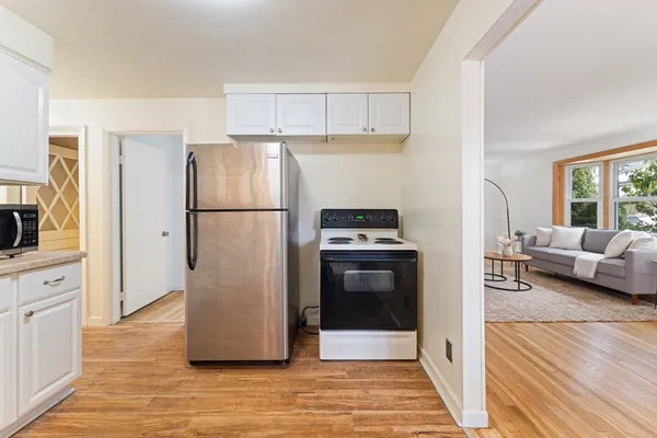 a white refrigerator freezer and a stove sitting inside of a kitchen