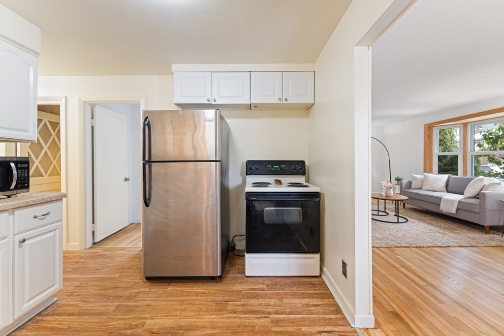 35 Dustin Street Worcester, MA 01604 - Photo 11 of 32 a white refrigerator freezer and a stove sitting inside of a kitchen
