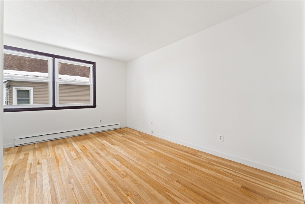 35 Dustin Street Worcester, MA 01604 - Photo 16 of 32 a view of empty room with wooden floor and fan