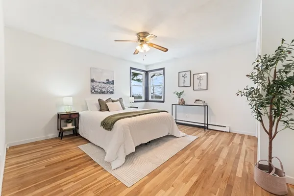 a bedroom with a large bed and a chandelier