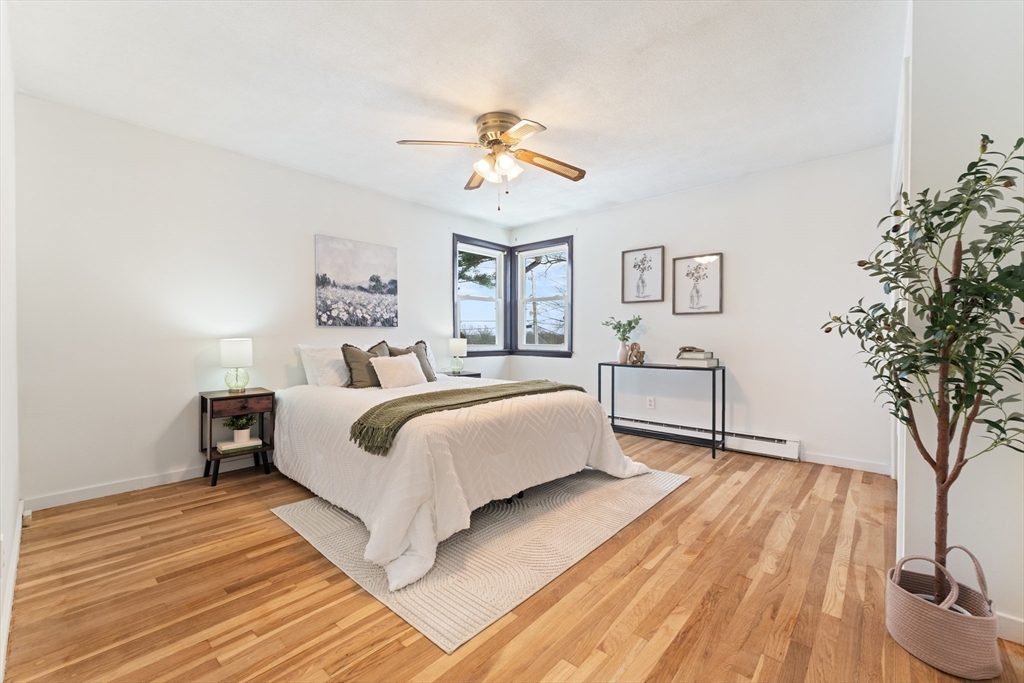 35 Dustin Street Worcester, MA 01604 - Photo 17 of 32 a bedroom with a large bed and a chandelier