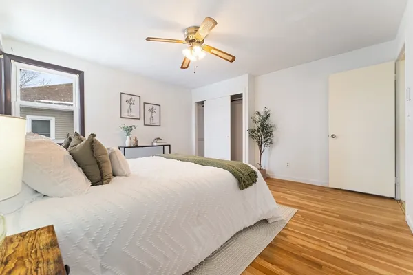 a bedroom with a large bed and a chandelier