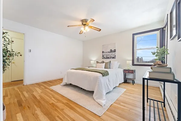 a bedroom with a bed and wooden floor