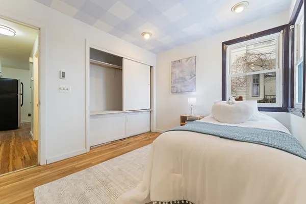 a bedroom with a large bed and a flat screen tv