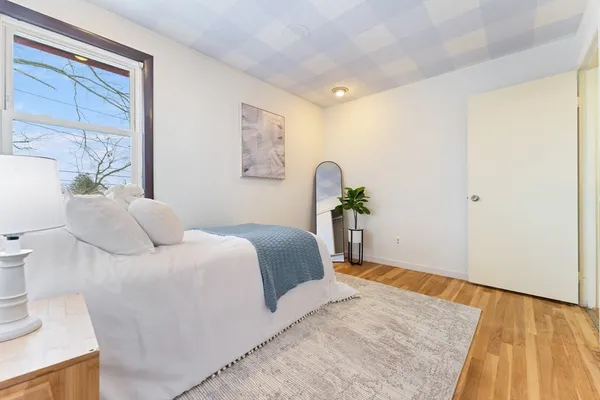 a bedroom with a bed and a window