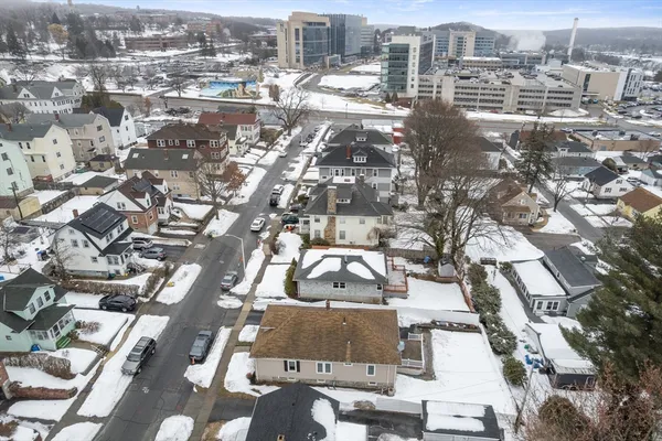 an aerial view of residential houses with city view
