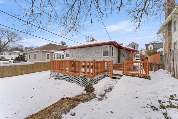 a view of a house with a wooden fence