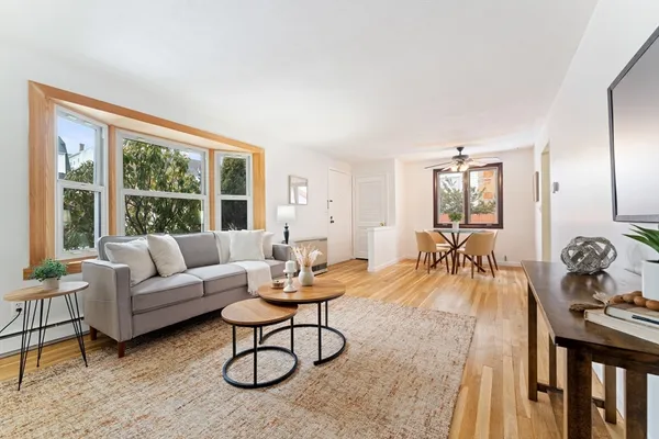 a living room with furniture and a large window