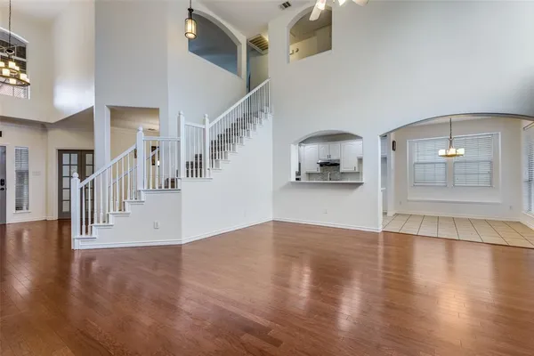 a view of a livingroom with wooden floor and stairs