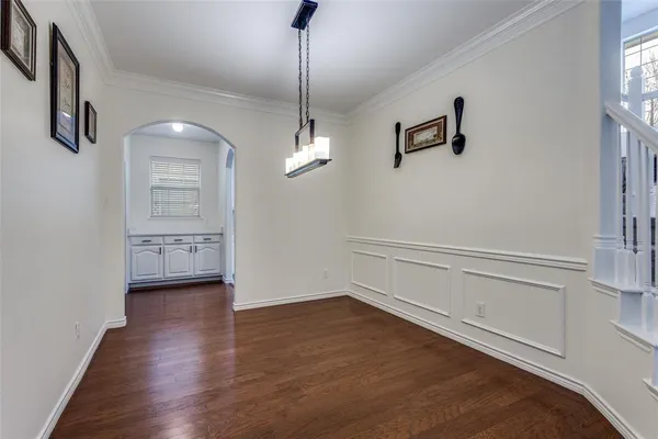 a view of a livingroom with wooden floor and a ceiling fan