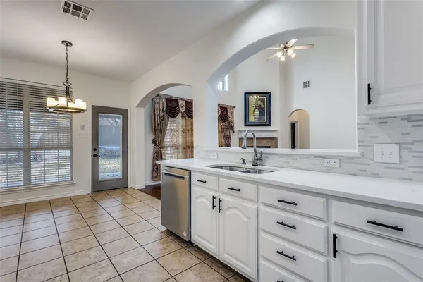 a spacious bathroom with a granite countertop sink mirror and shower