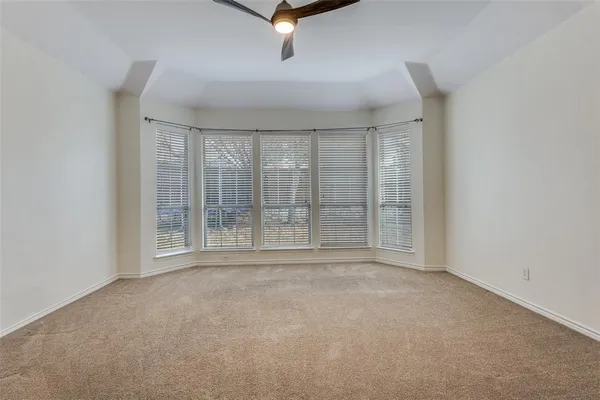 a view of an empty room with windows