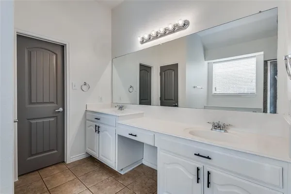 a spacious bathroom with a double vanity sink mirror and