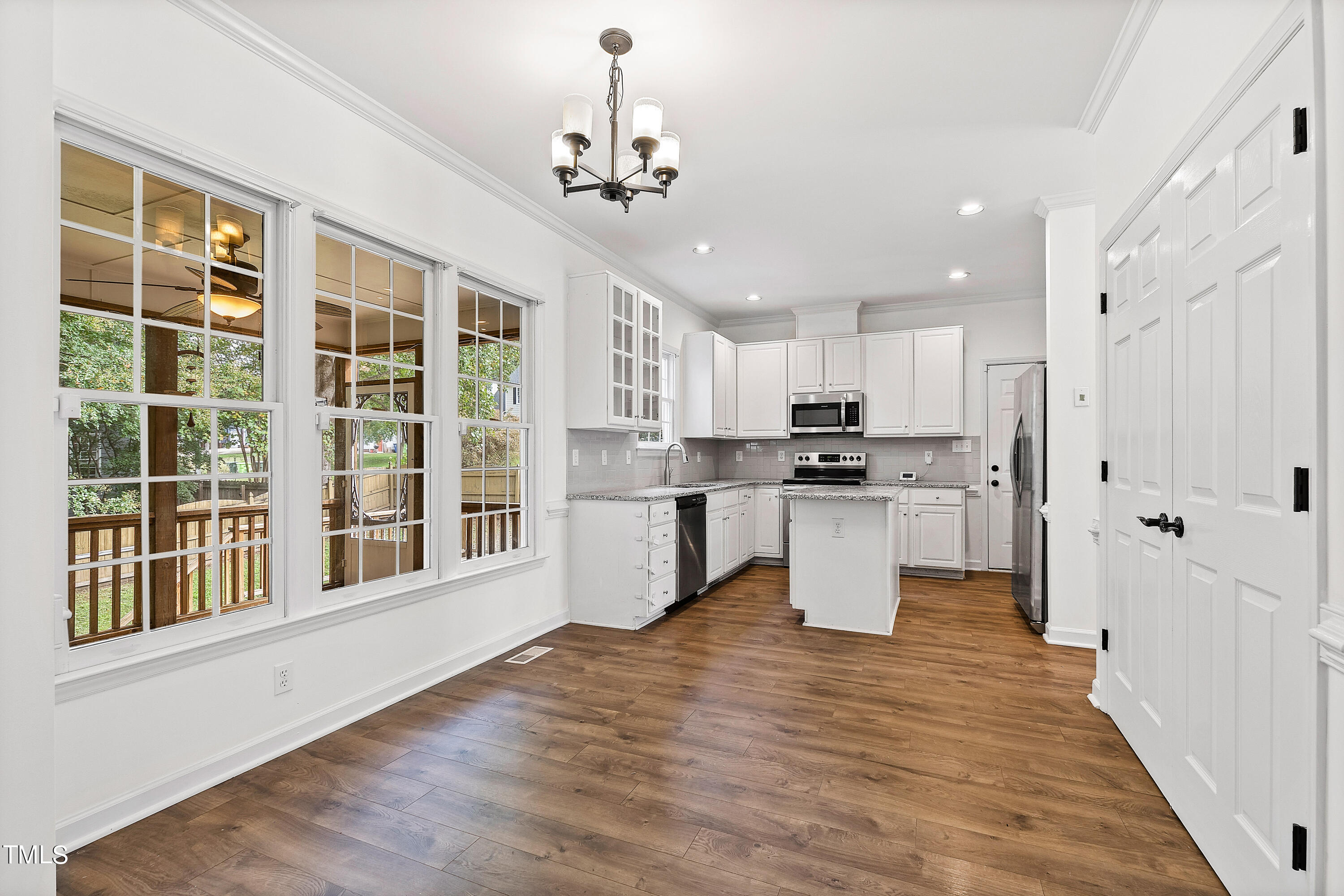 4305 Riverport Road Raleigh, NC 27616 - Photo 12 of 43 a kitchen with stainless steel appliances kitchen island granite countertop a refrigerator and a stove top oven