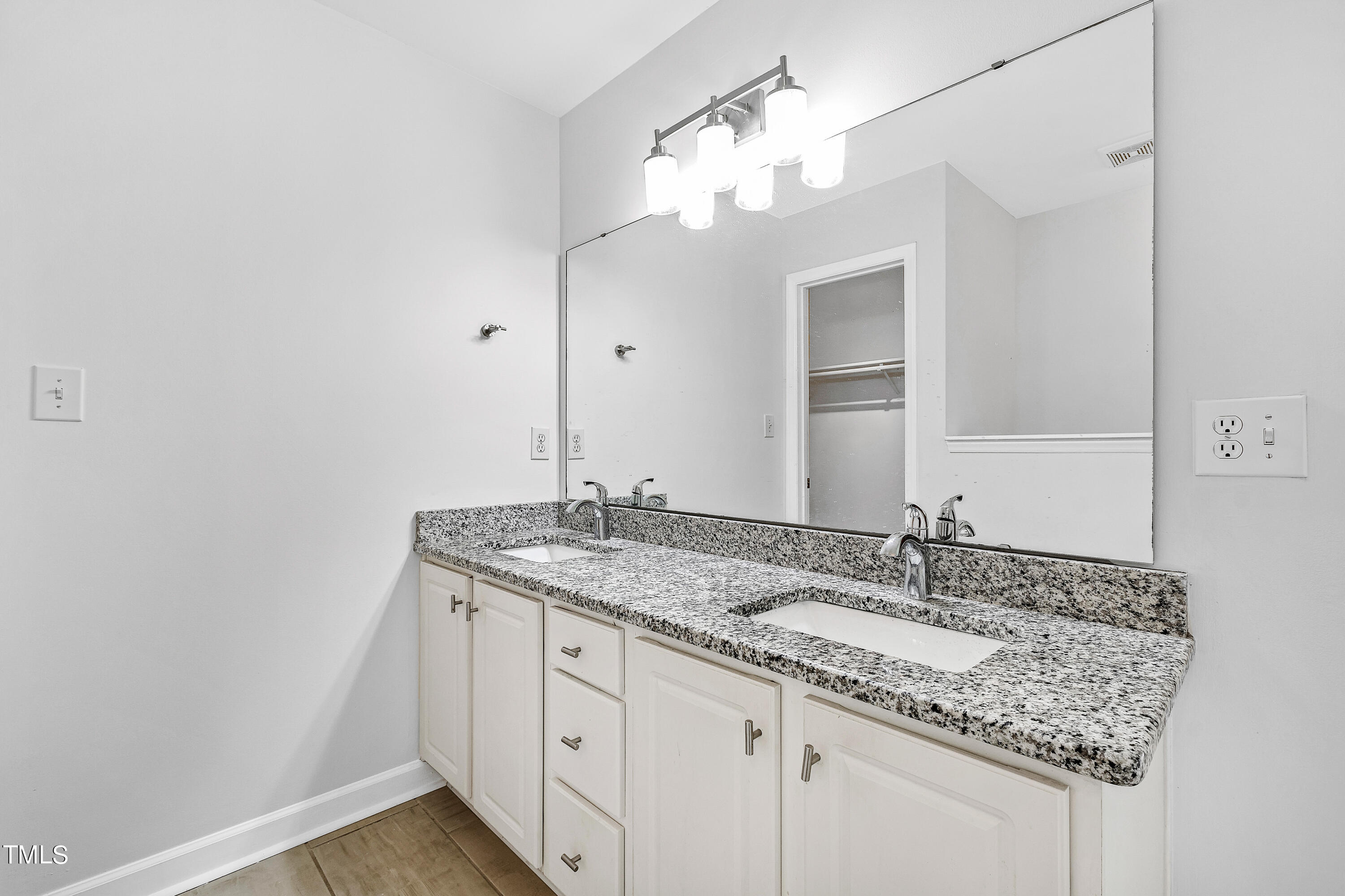4305 Riverport Road Raleigh, NC 27616 - Photo 22 of 43 a bathroom with a granite countertop sink a large mirror and vanity