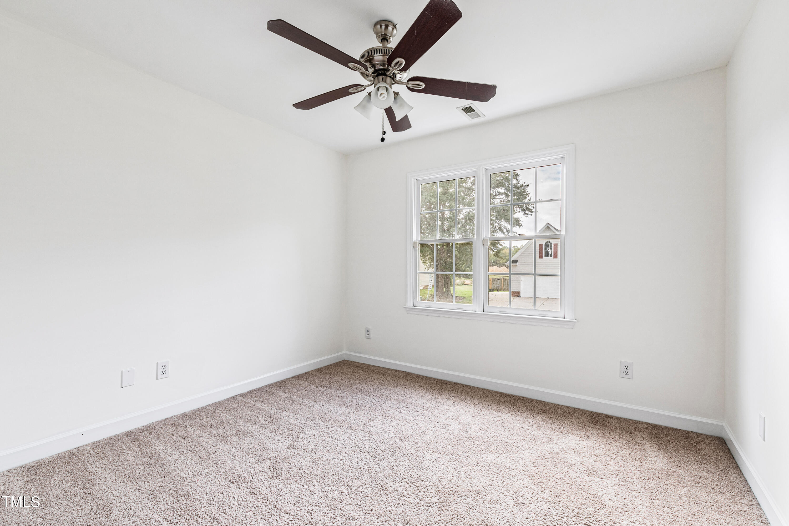 4305 Riverport Road Raleigh, NC 27616 - Photo 32 of 43 an empty room with a window and a fan