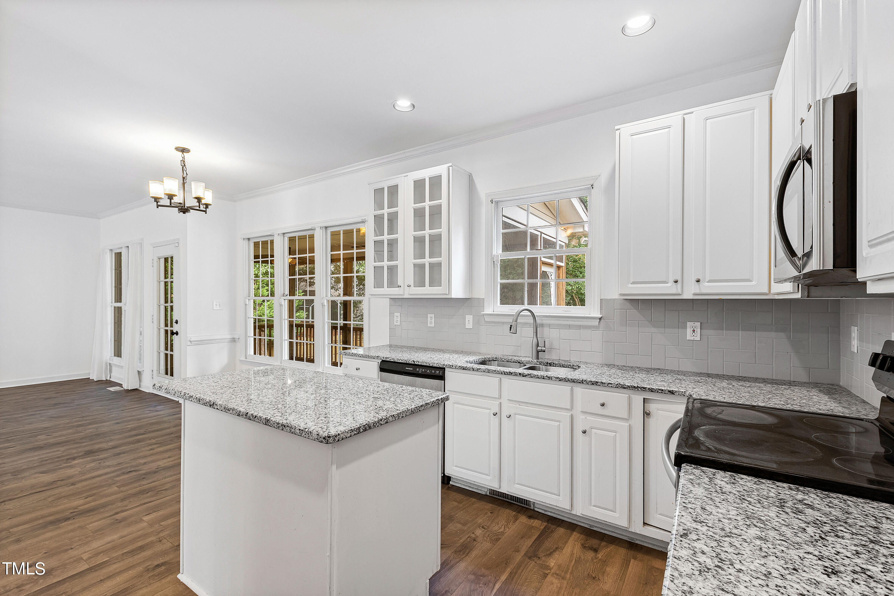 4305 Riverport Road Raleigh, NC 27616 - Photo 10 of 43 a kitchen with granite countertop a sink cabinets and wooden floor