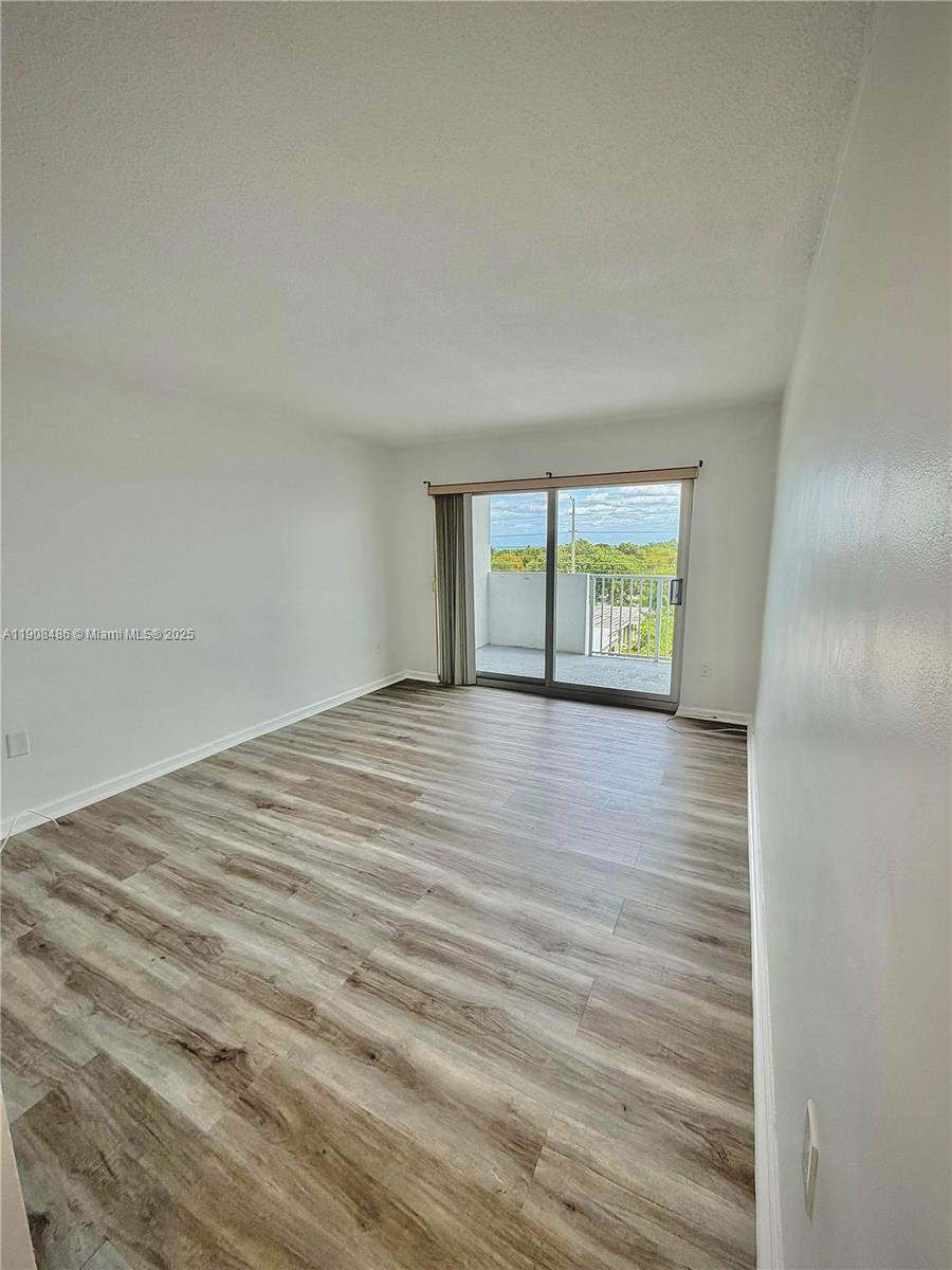 8000 Harding Avenue, Unit 5C Miami Beach, FL 33141 - Photo 4 of 13 a view of an empty room with a window