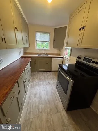 a kitchen with wooden floors and a stove