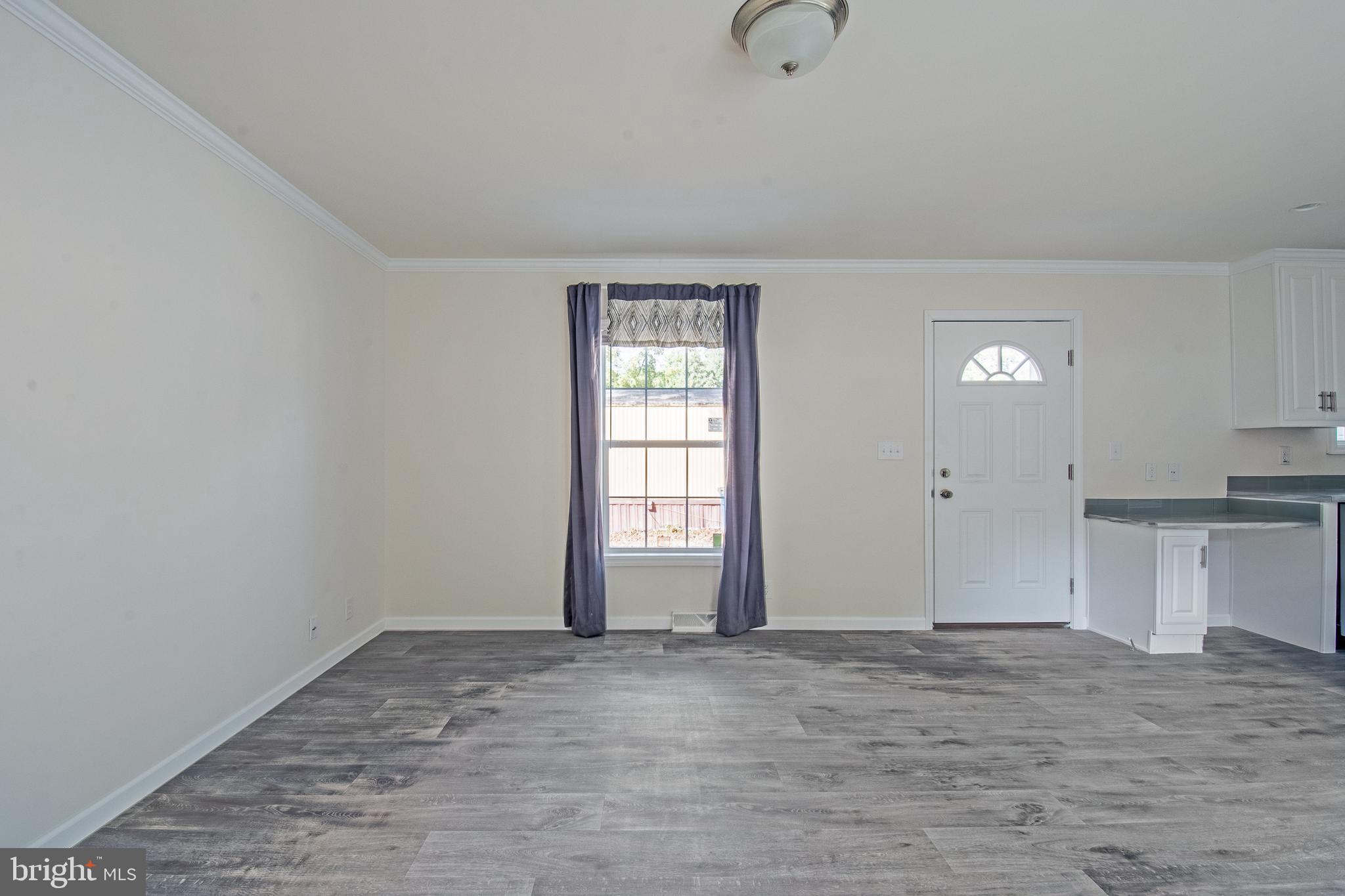 91 Longbow Lane Hartly, DE 19953 - Photo 15 of 21 a view of an empty room with window and wooden floor