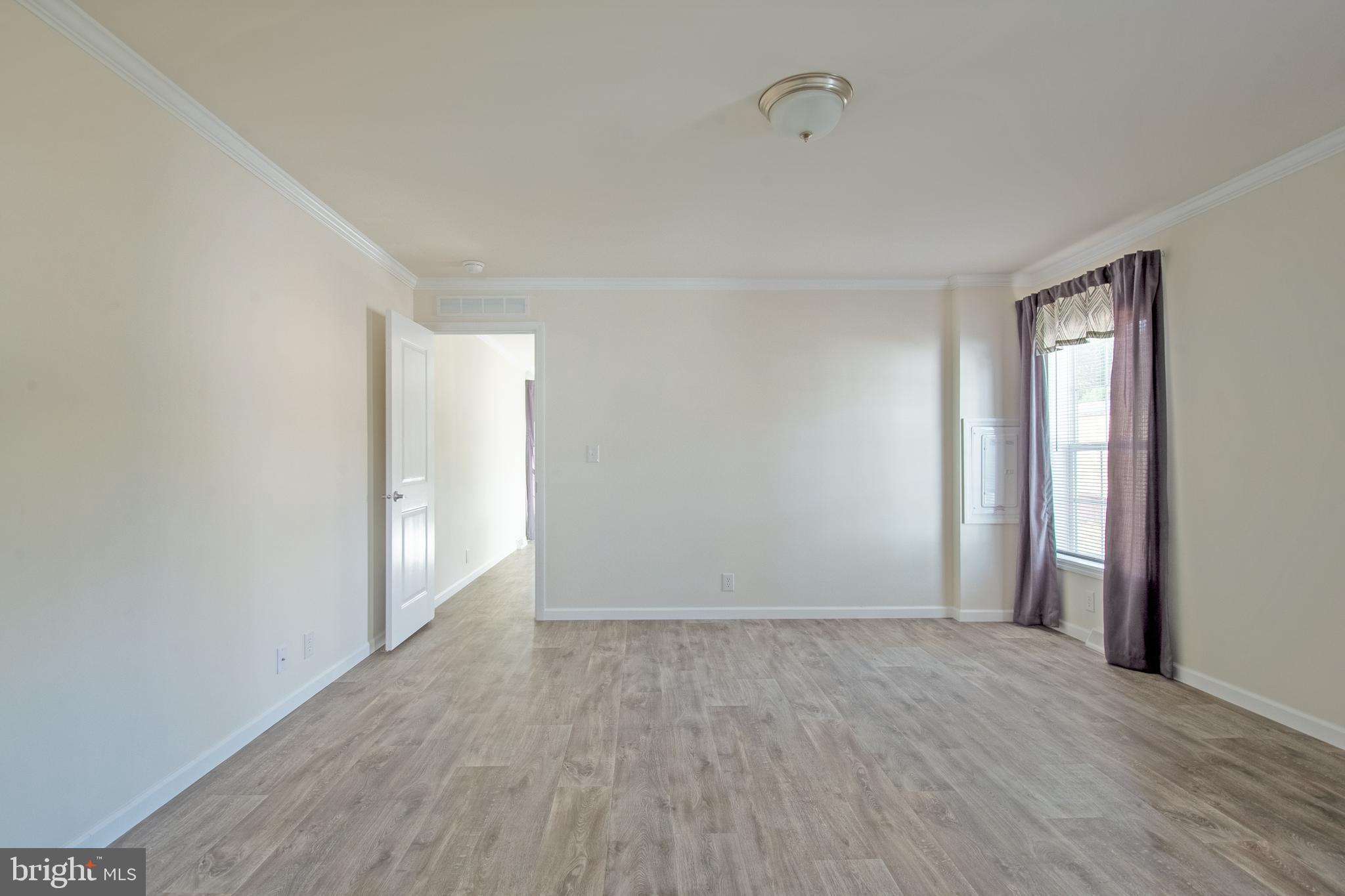 91 Longbow Lane Hartly, DE 19953 - Photo 9 of 21 a view of an empty room with wooden floor and a window