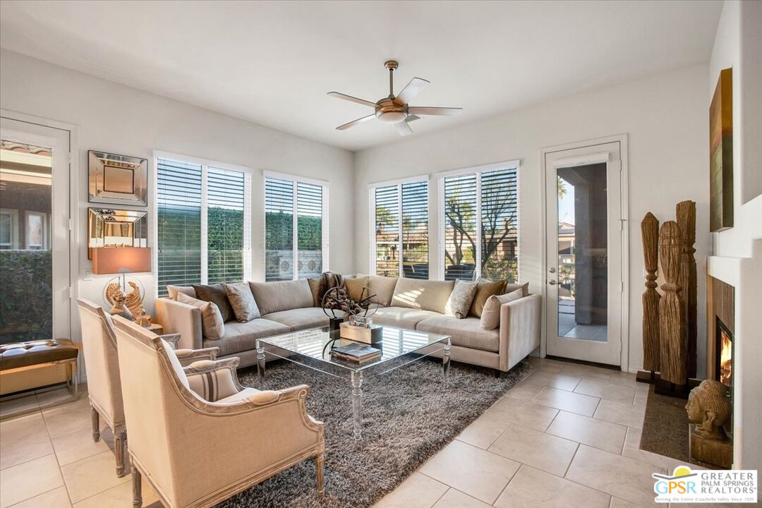 8 Lake Como Court Rancho Mirage, CA 92270 - Photo 11 of 63 a living room with furniture and large windows