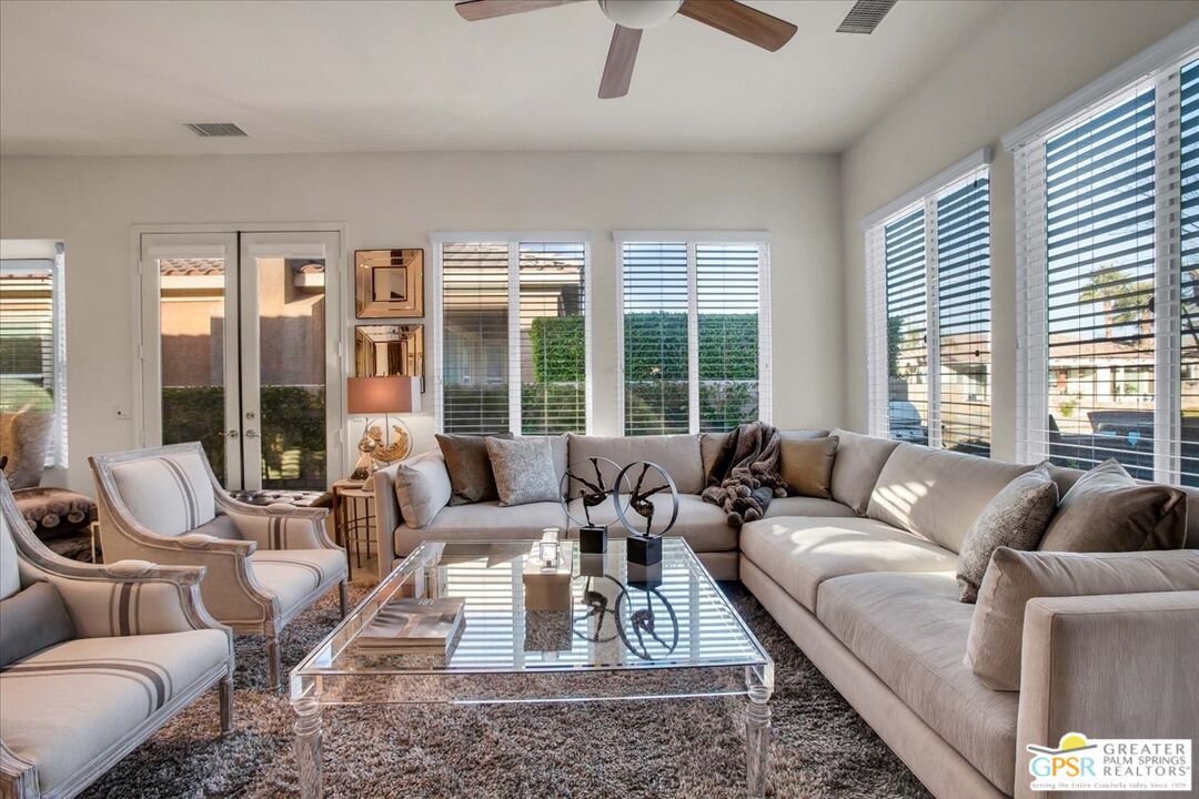 8 Lake Como Court Rancho Mirage, CA 92270 - Photo 13 of 63 a living room with furniture large windows and wooden floor