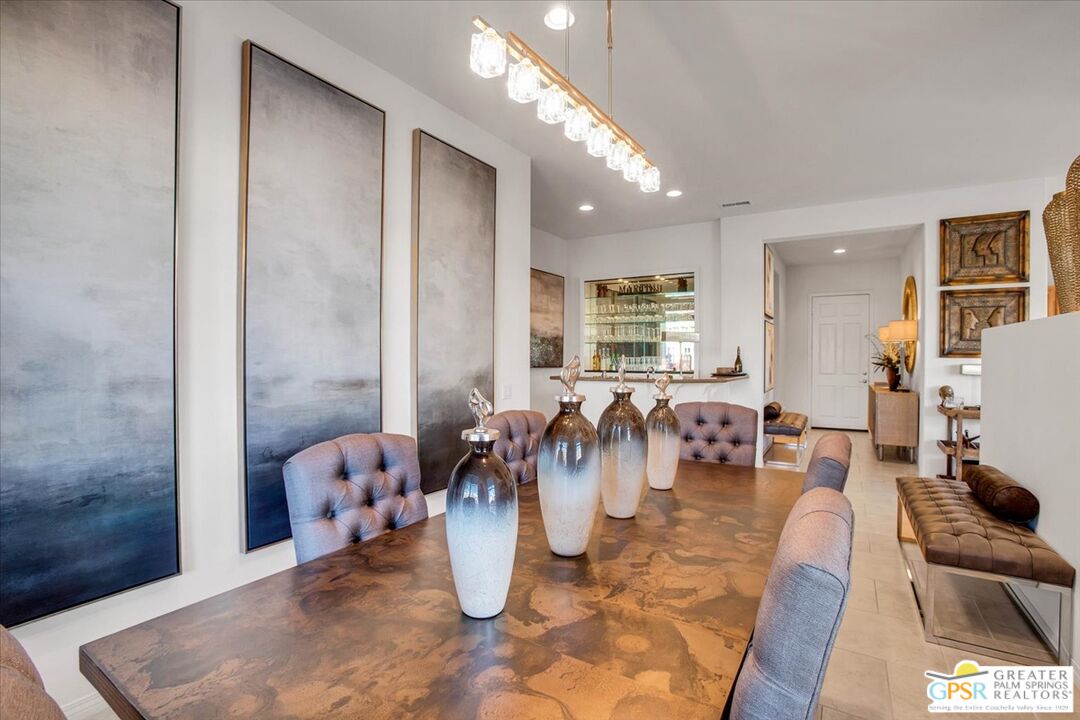 8 Lake Como Court Rancho Mirage, CA 92270 - Photo 25 of 63 a dining room with lots of furniture and a chandelier