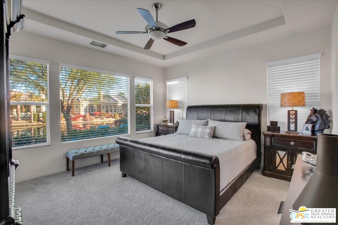 8 Lake Como Court Rancho Mirage, CA 92270 - Photo 26 of 63 a bedroom with a large bed and a large window