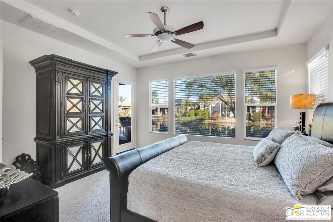 8 Lake Como Court Rancho Mirage, CA 92270 - Photo 27 of 63 a spacious bedroom with a large bed and a window