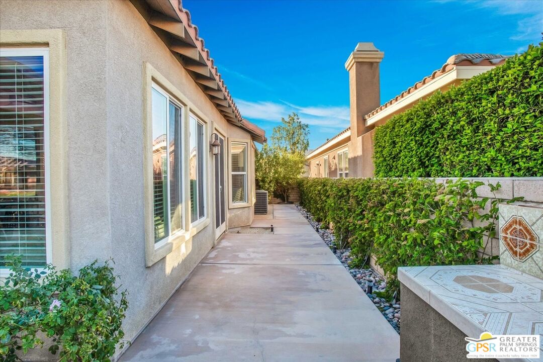 8 Lake Como Court Rancho Mirage, CA 92270 - Photo 42 of 63 a porch with seating space and yard in the back