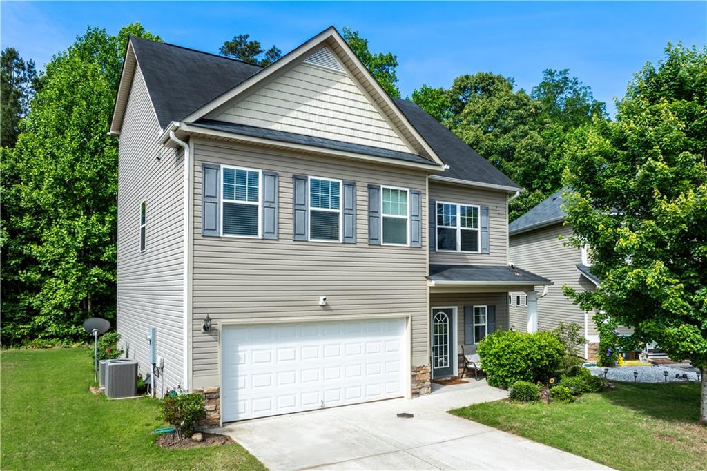 a front view of a house with a yard and garage