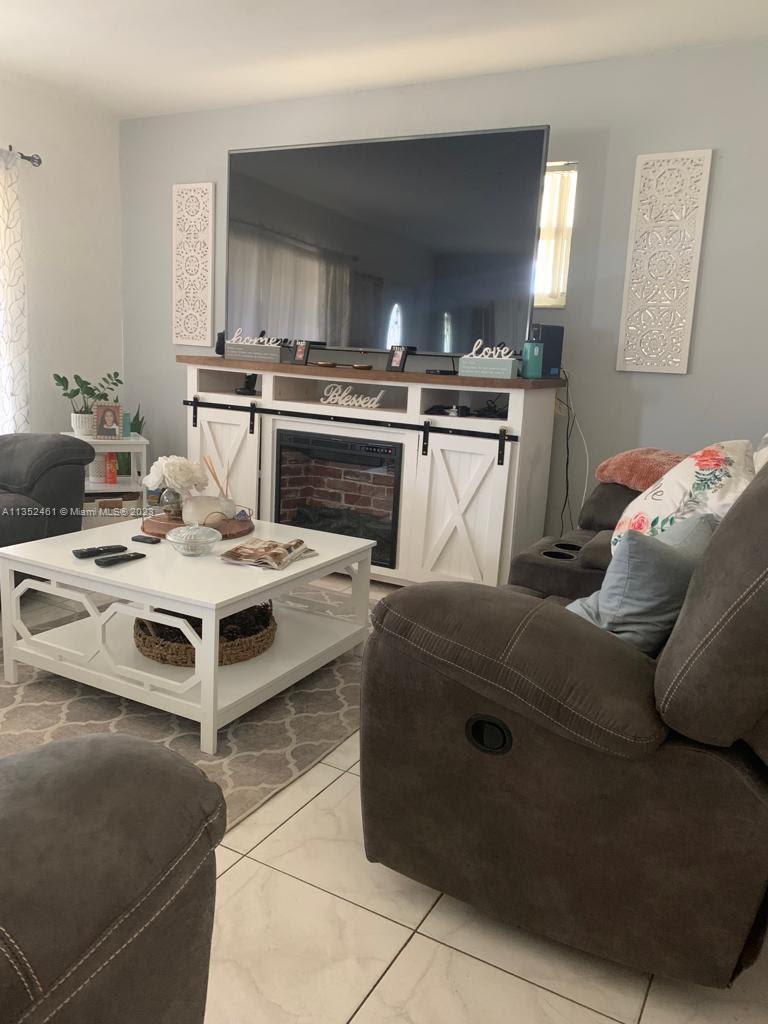 506 Jersey Road West Lehigh Acres, FL 33936 - Photo 6 of 10 a kitchen with a stove a sink and a refrigerator