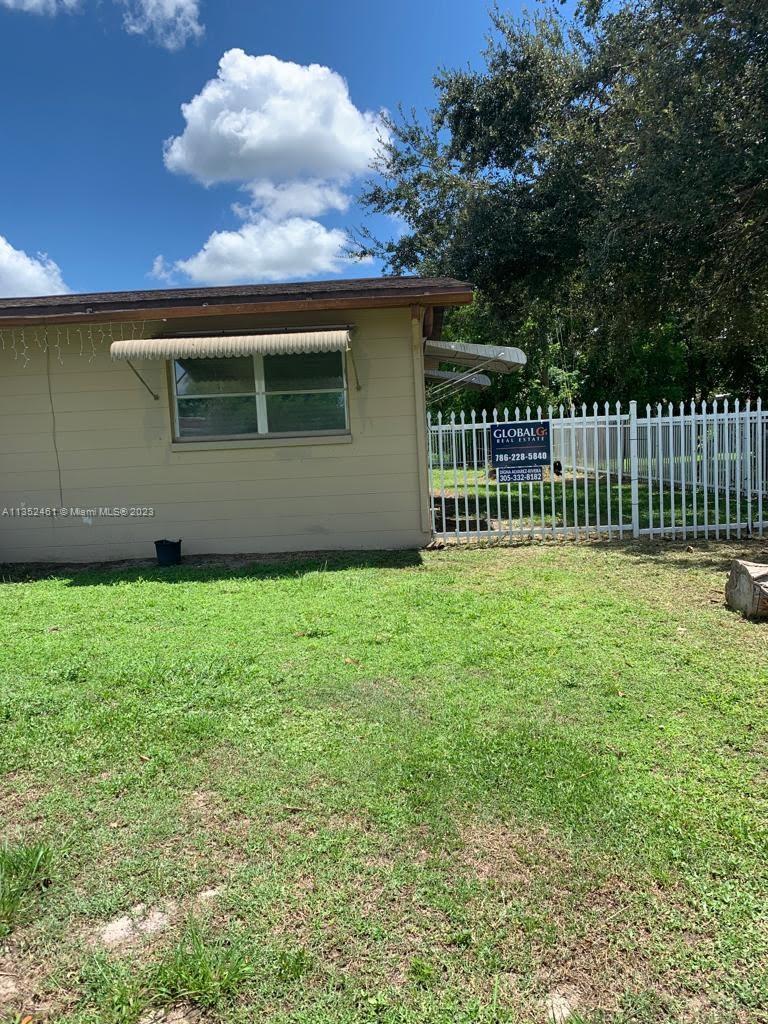 506 Jersey Road West Lehigh Acres, FL 33936 - Photo 8 of 10 a front view of a house having yard