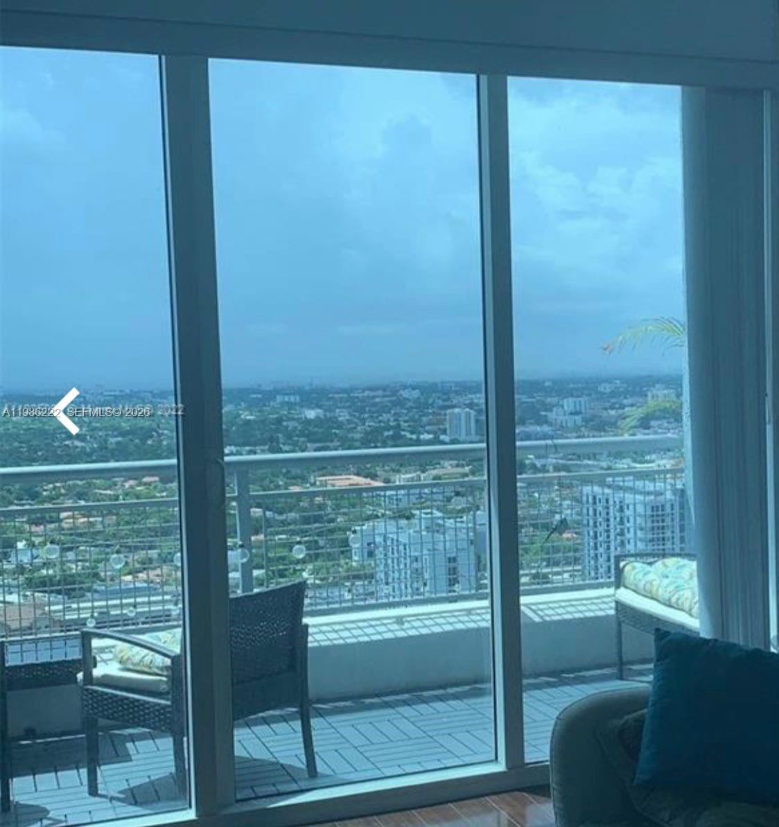 60 Southwest 13th Street, Unit 3017 Miami, FL 33130 - Photo 12 of 46 a view of a glass door and chair