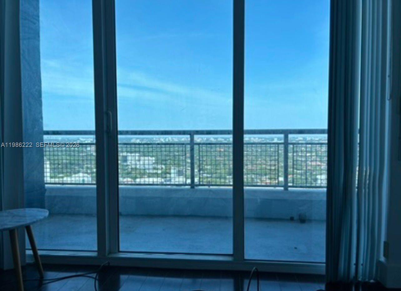 60 Southwest 13th Street, Unit 3017 Miami, FL 33130 - Photo 15 of 46 a view of a glass door with a balcony