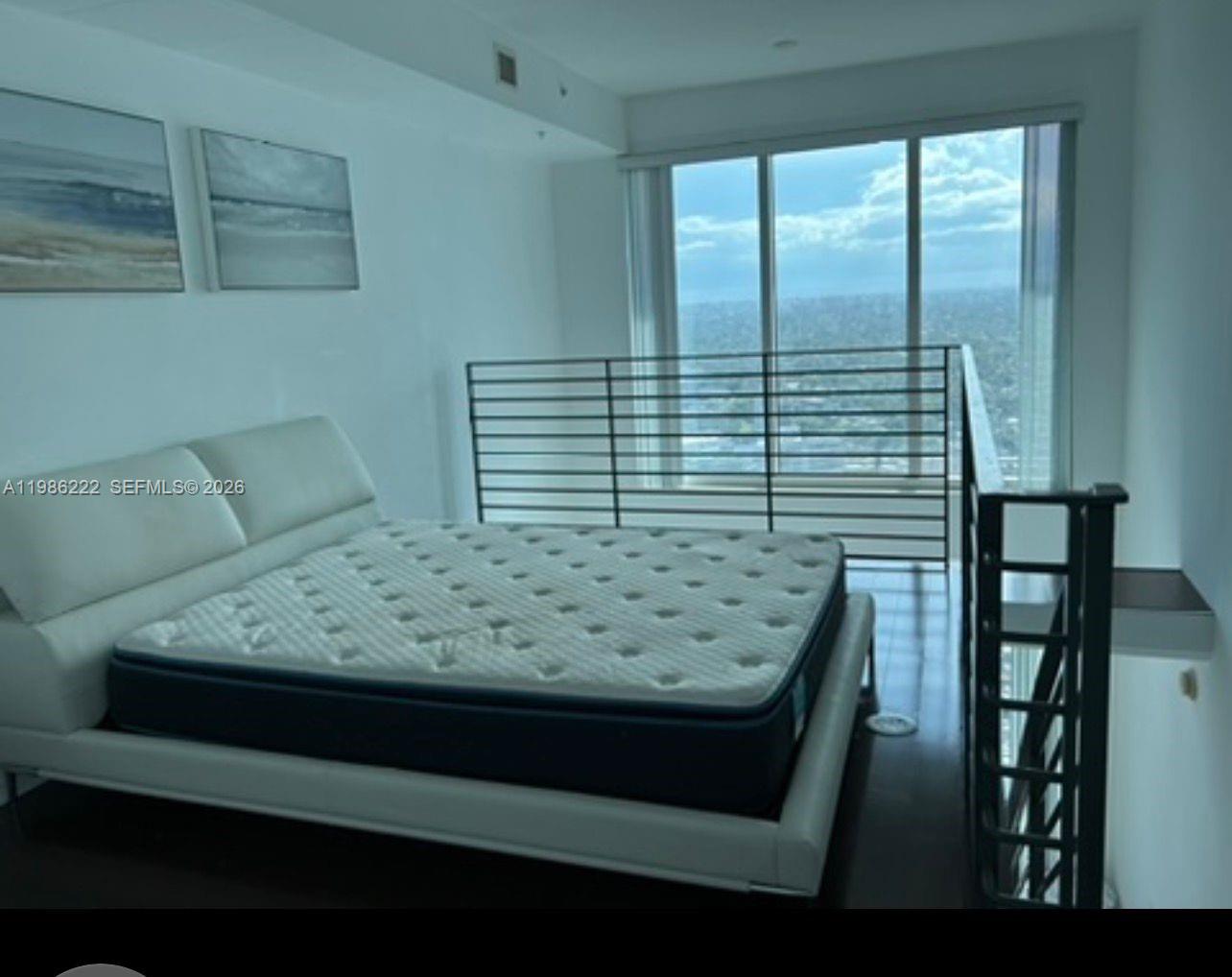 60 Southwest 13th Street, Unit 3017 Miami, FL 33130 - Photo 19 of 46 a view of wooden floor and chair in a room