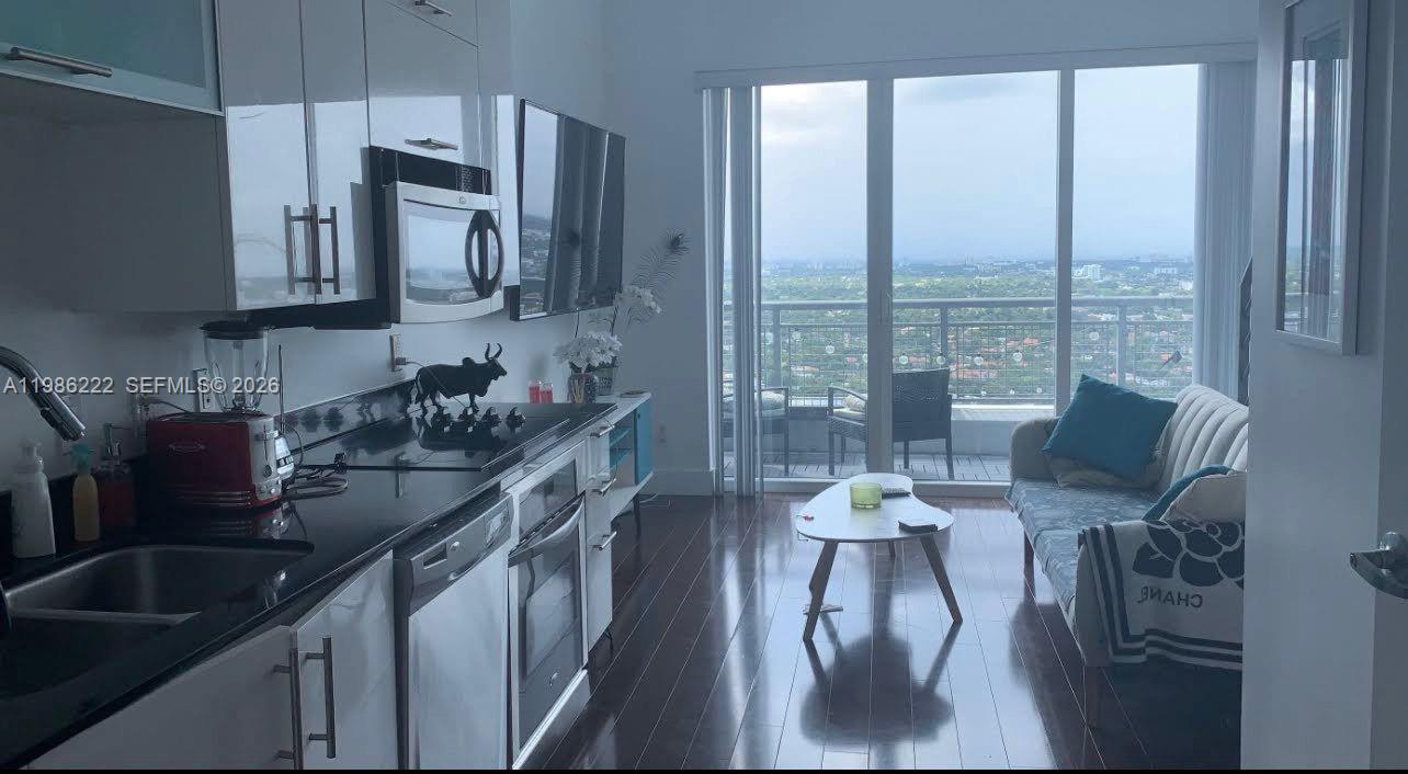 60 Southwest 13th Street, Unit 3017 Miami, FL 33130 - Photo 23 of 46 a kitchen with stainless steel appliances granite countertop a sink a stove and a refrigerator
