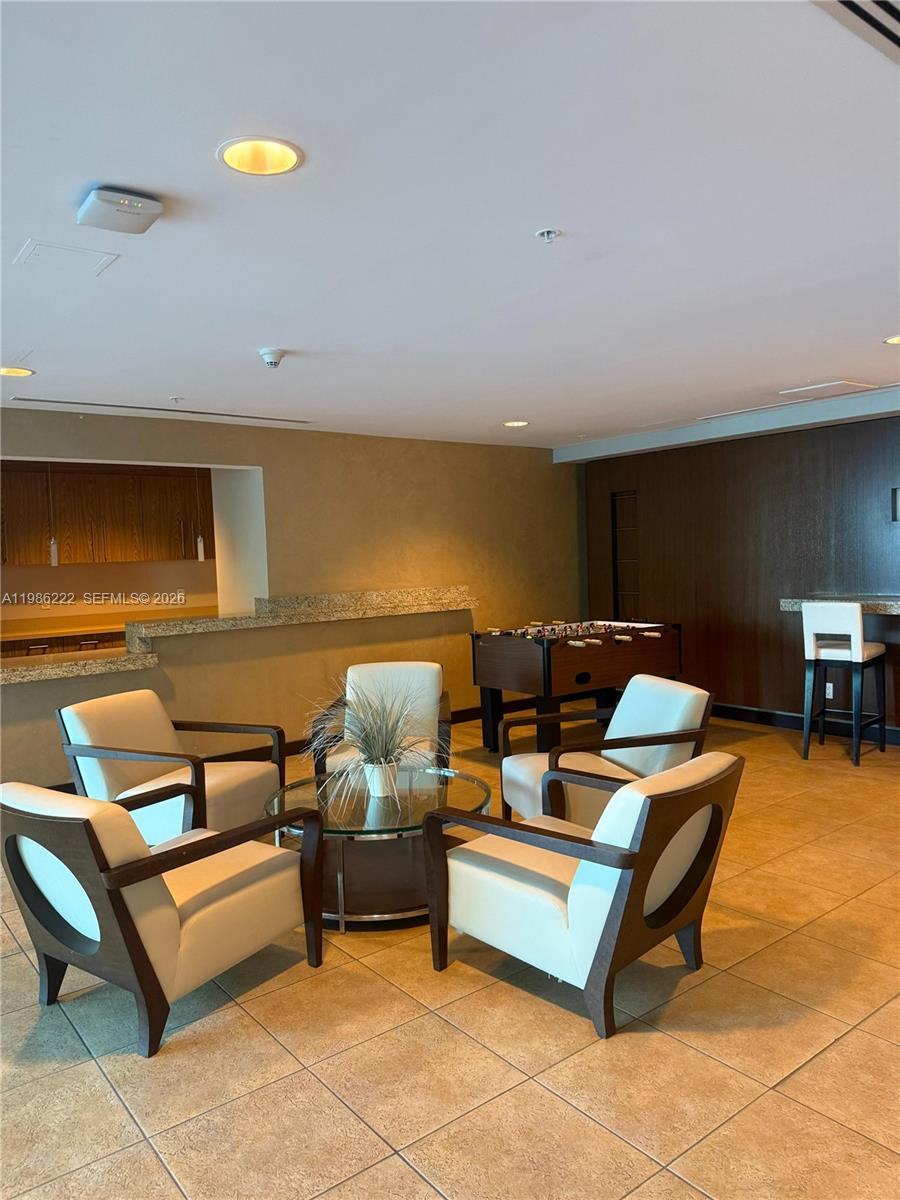 60 Southwest 13th Street, Unit 3017 Miami, FL 33130 - Photo 27 of 46 a living room with furniture and a flat screen tv